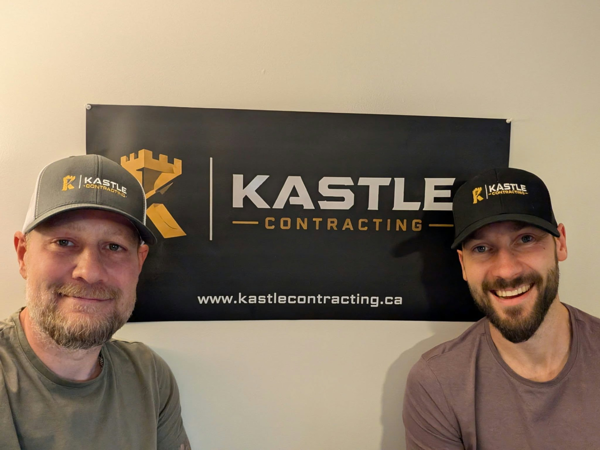 Kent and Martin, owners of Kastle Contracting, in front of their branded work vehicle