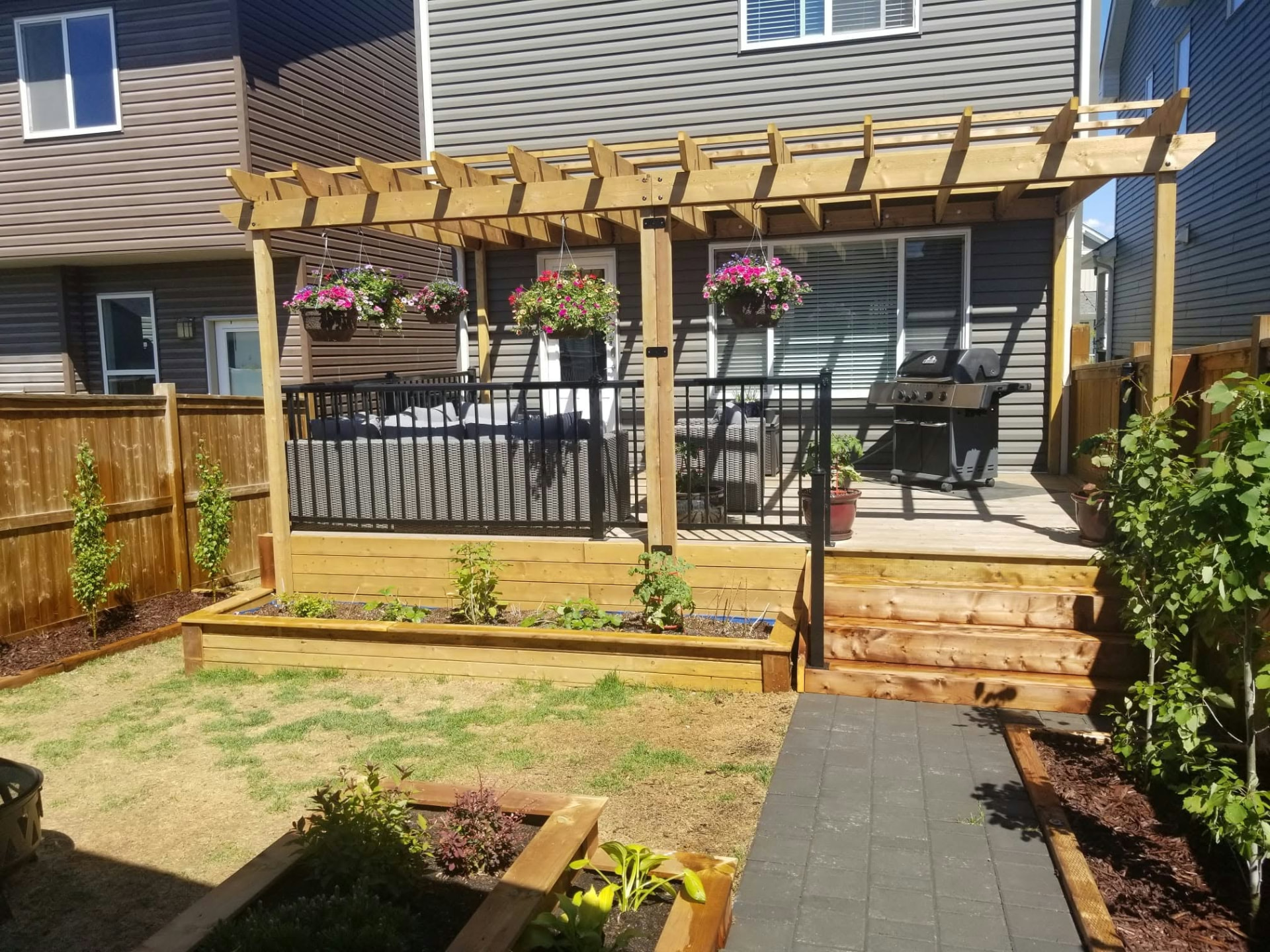 Backyard pergola, deck, stairs, and raised garden beds