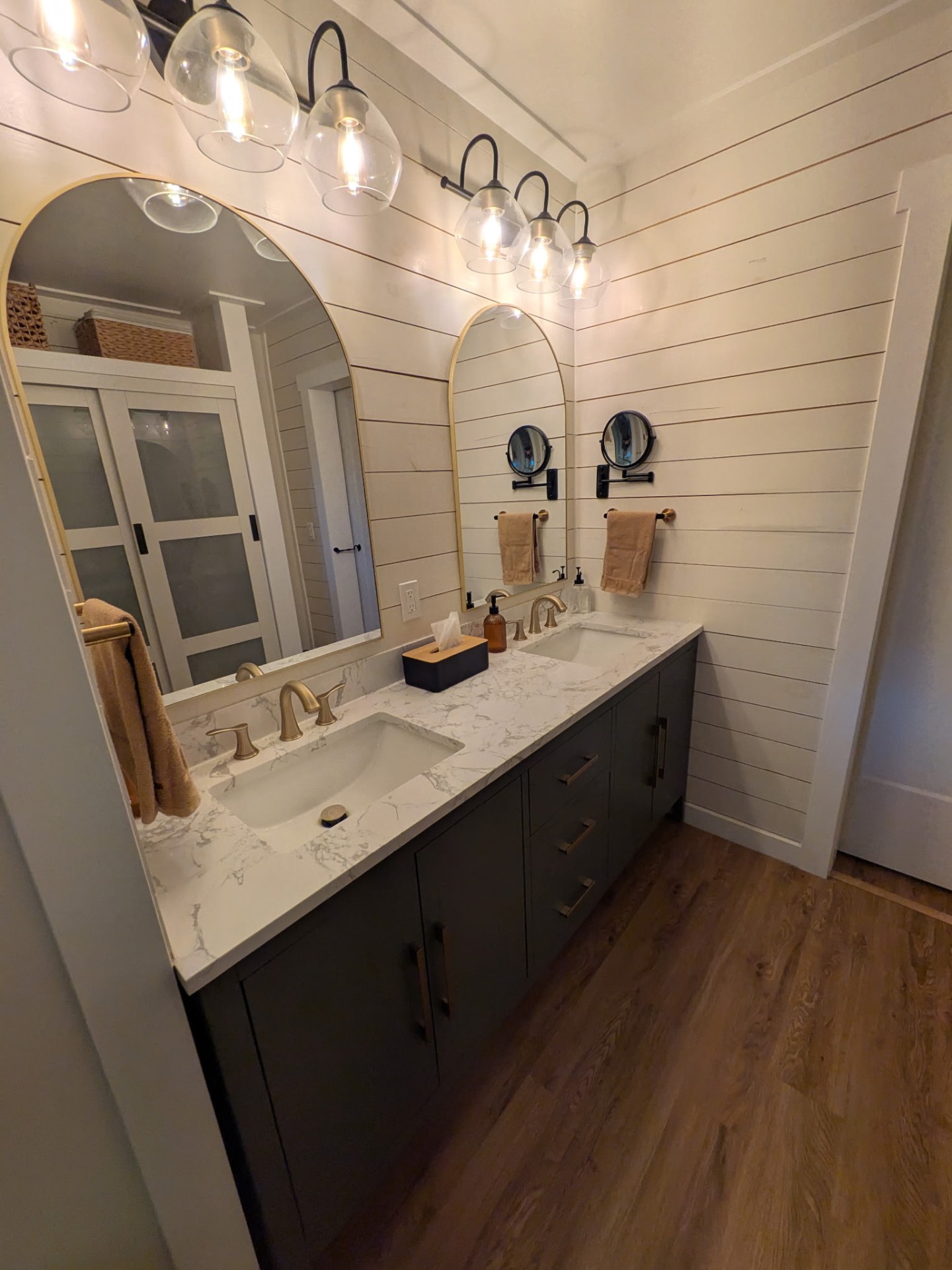 Double vanity bathroom remodel with shiplap and arched mirrors